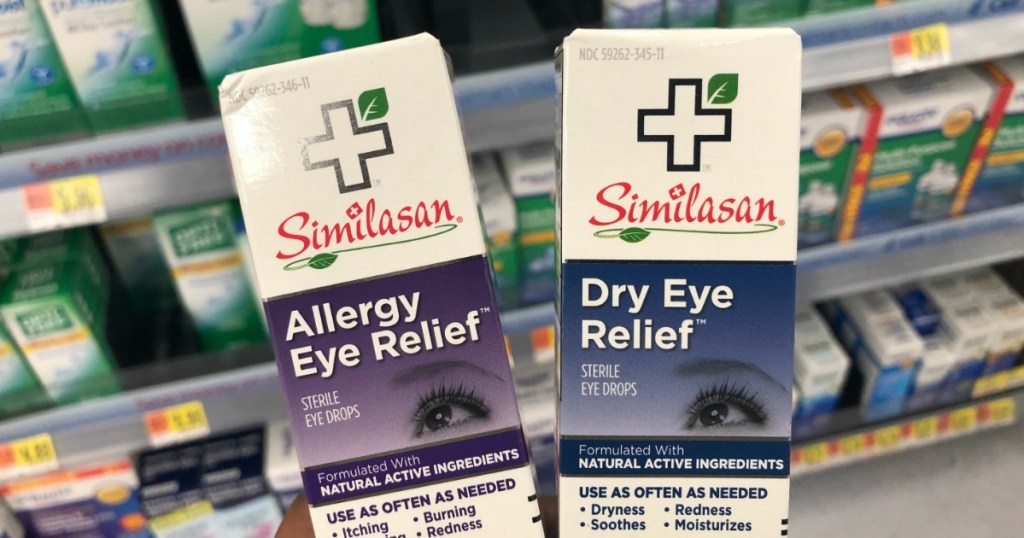 hand holding two boxes of Similasan eye drops