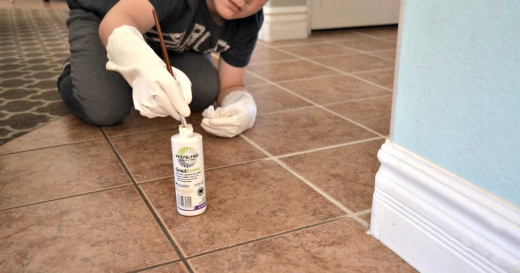 boy painting grout lines on tile floor - selling your home