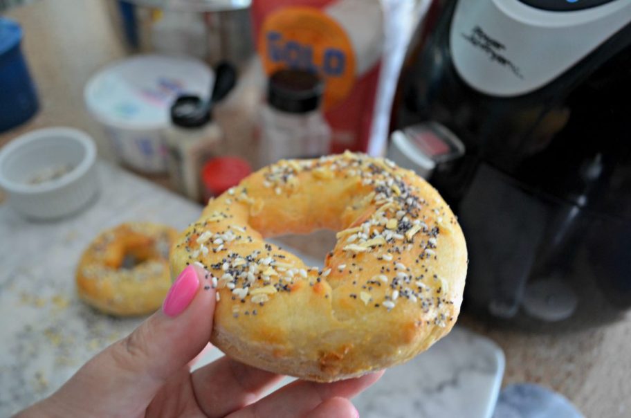 hand holding everything bagel