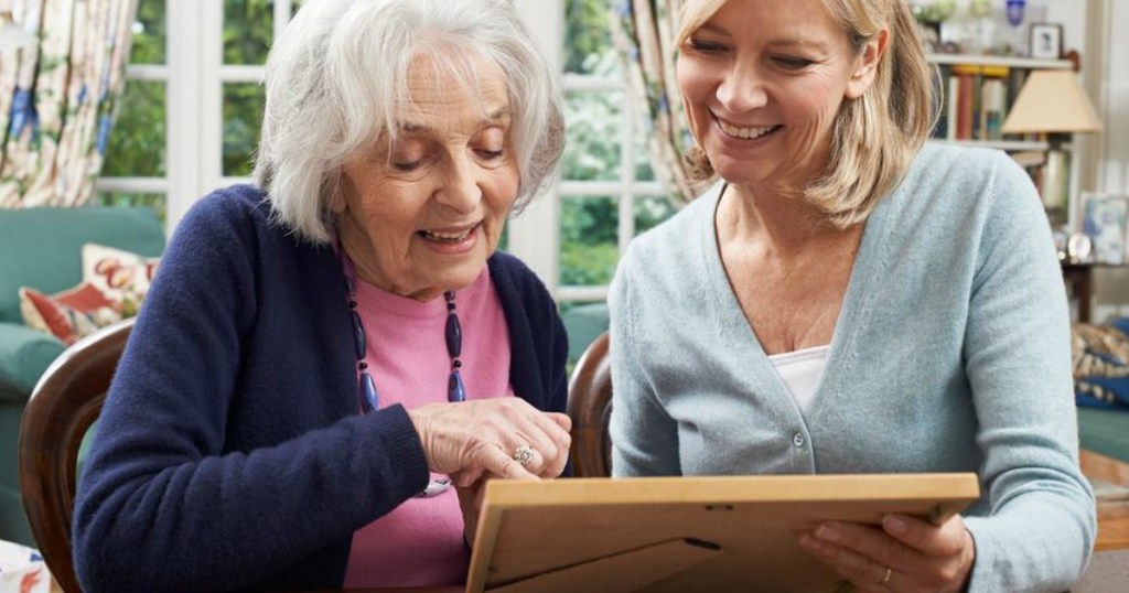 two women sitting next to each other smiling