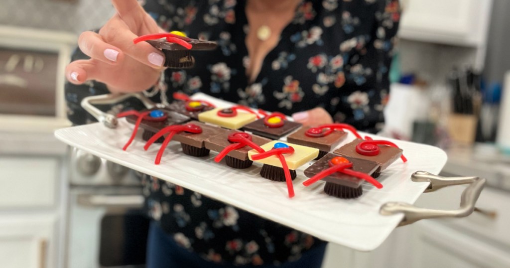 holding a tray with chocolate grad hats