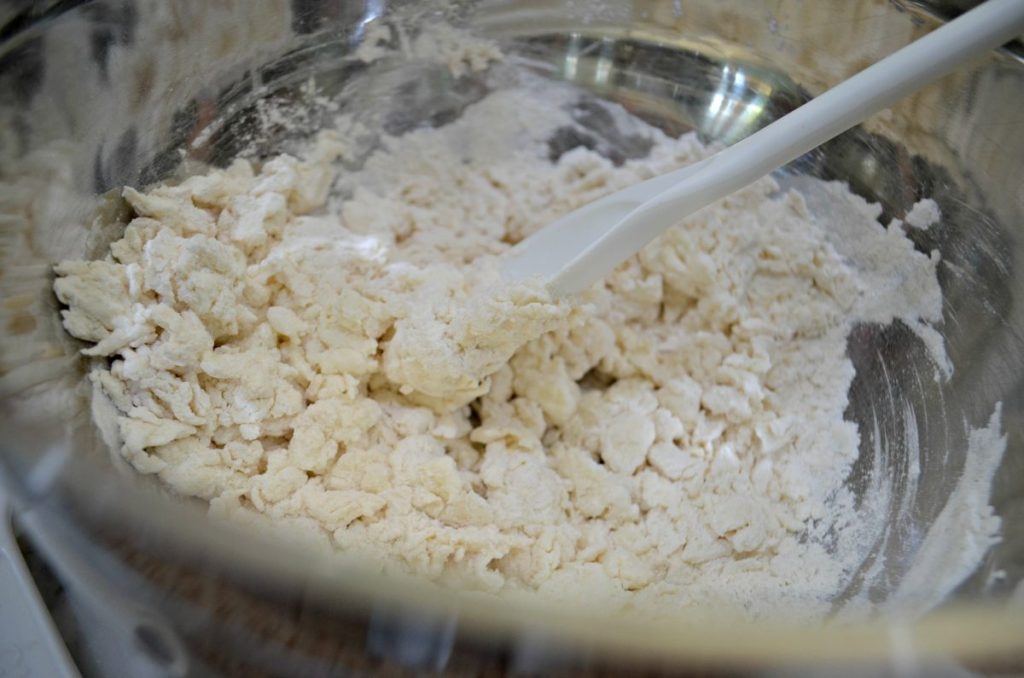 dough being stirred with spoon