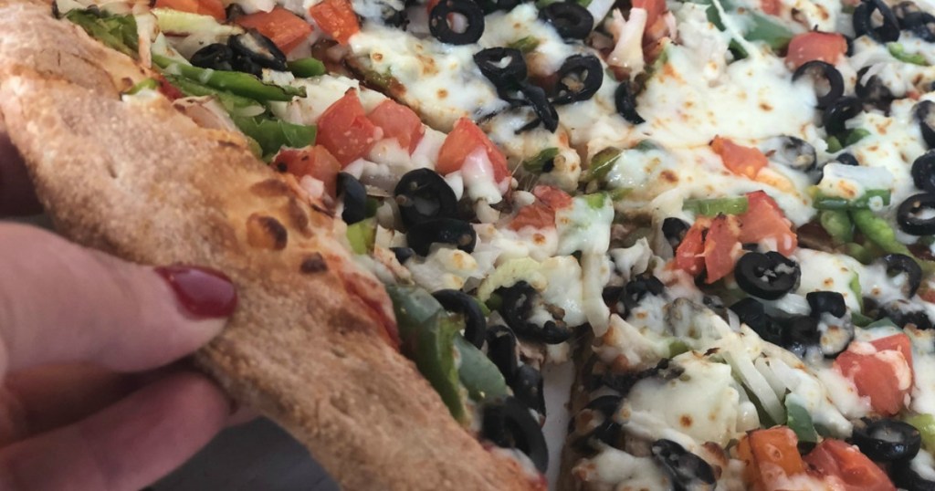 hand grabbing a piece of pizza