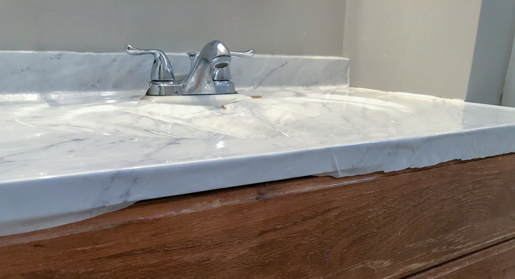 marble countertop DIY - roll and press paper over edges