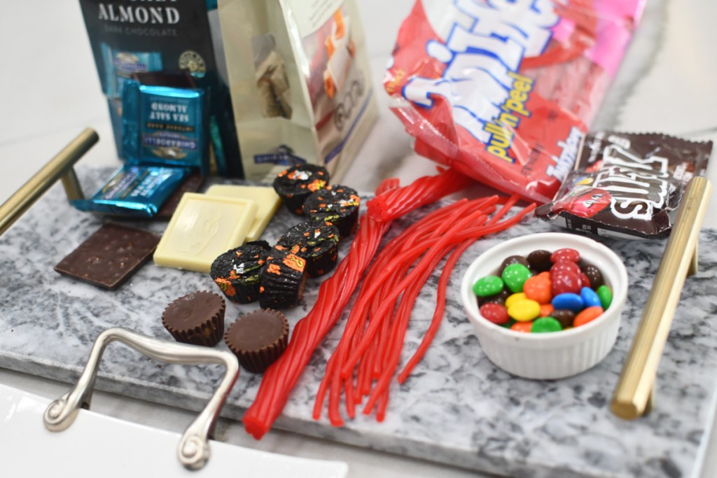 supplies to make graduation cap treats on a tray