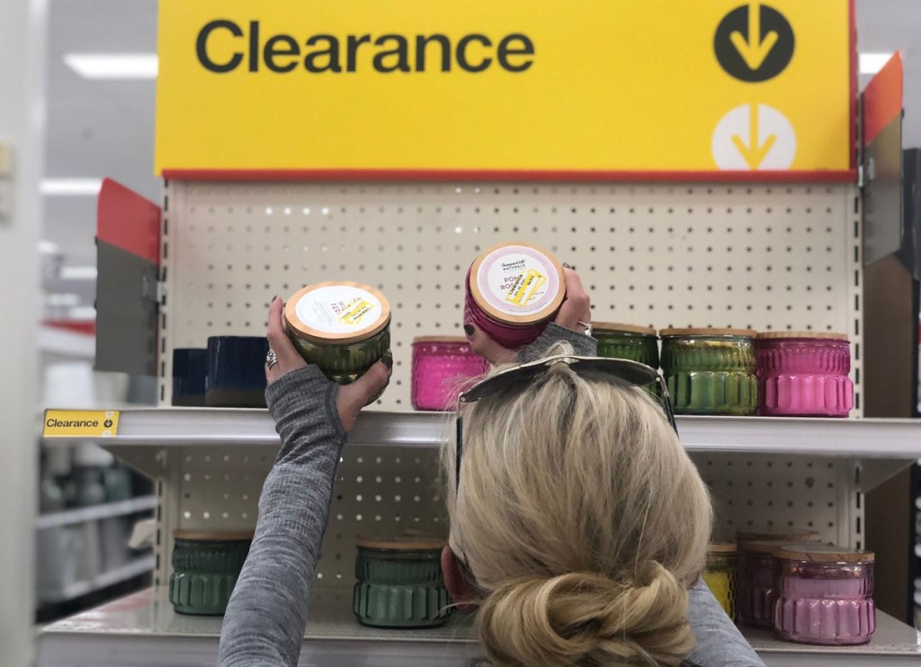 woman picking up clearance candles at Target 
