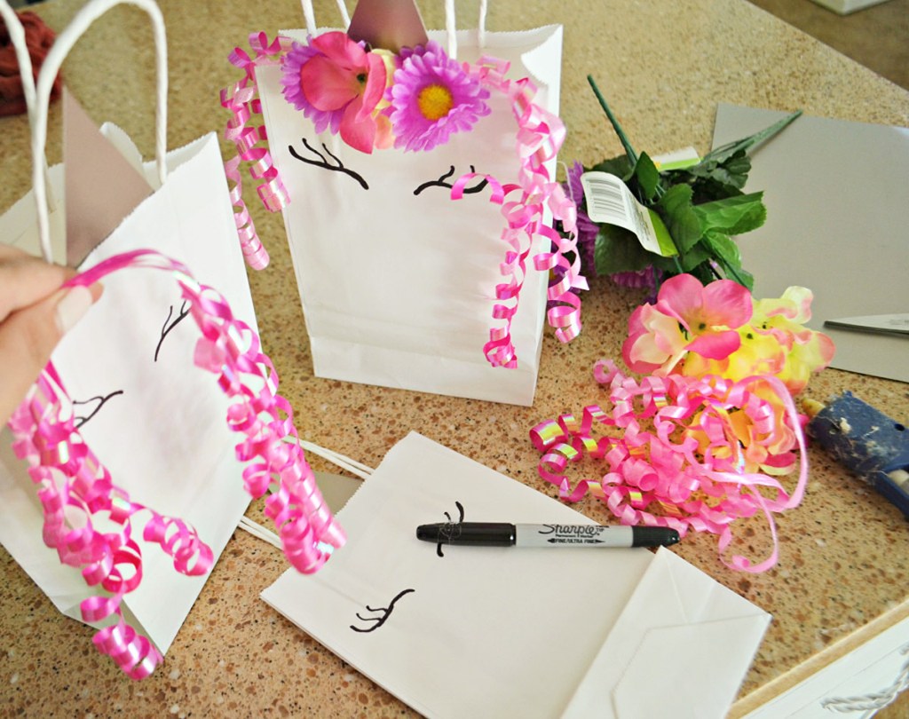 sharpie on top of unicorn bag with pink ribbon decorations