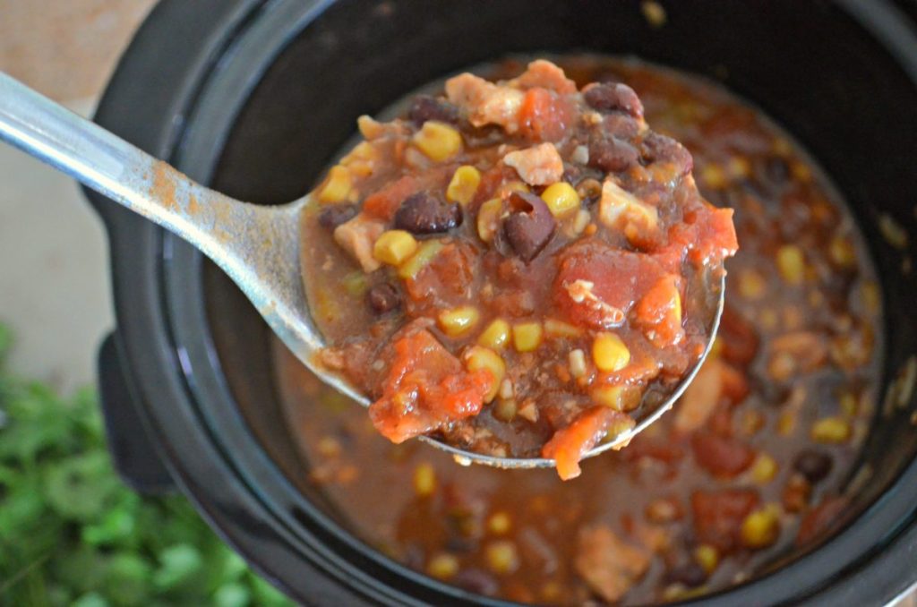 chicken chili on a spoon over slow cooker