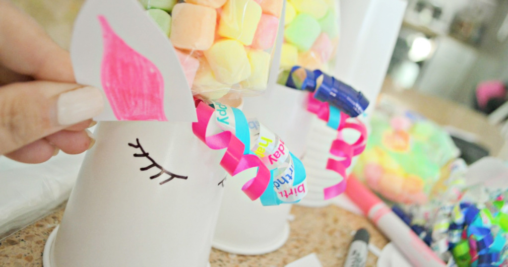 colorful marshmallows on top of unicorn decorated cups