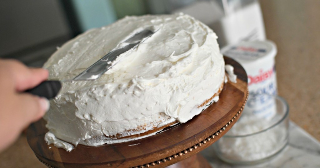 frosting a coconut cake with cool whip