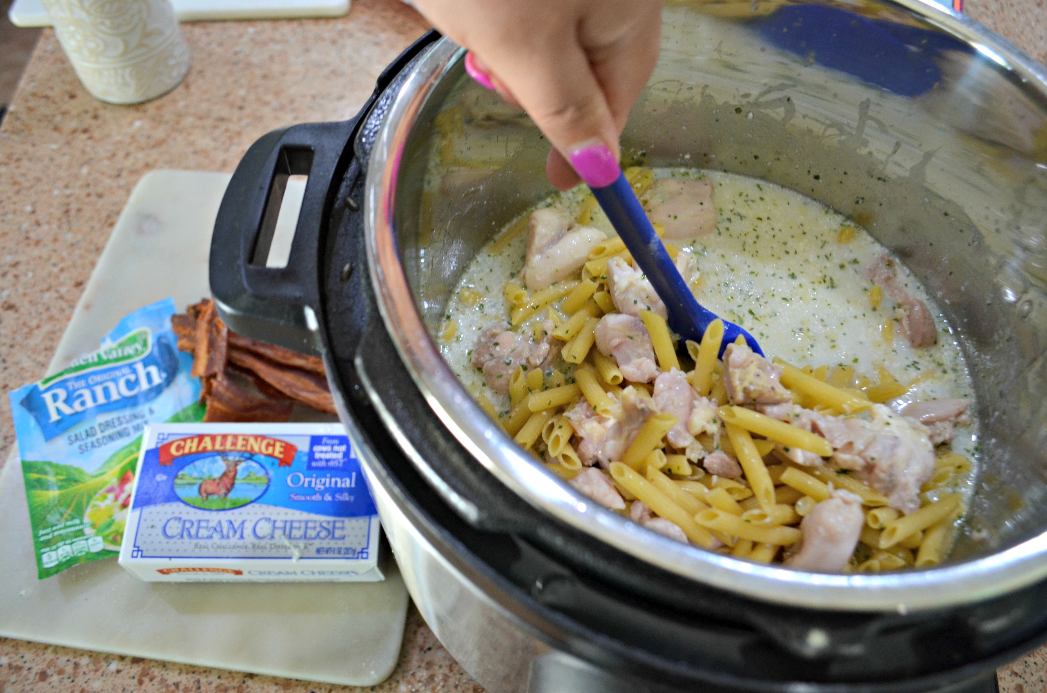 Instant Pot Chicken Ranch Pasta with Bacon – Stirring noodles and chicken in the instant pot