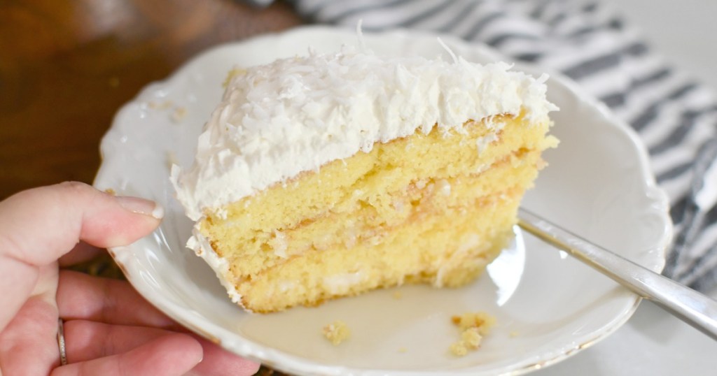 plate with a slice of coconut sour cream cake