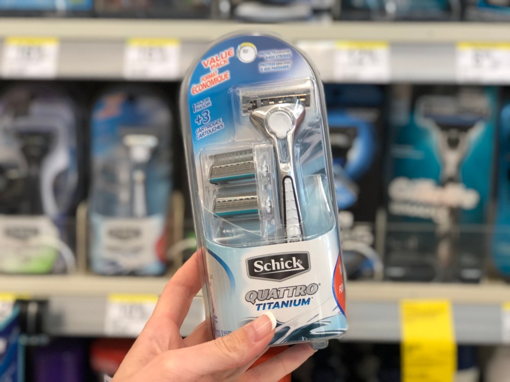 Hand holding up schick quattro men's razor