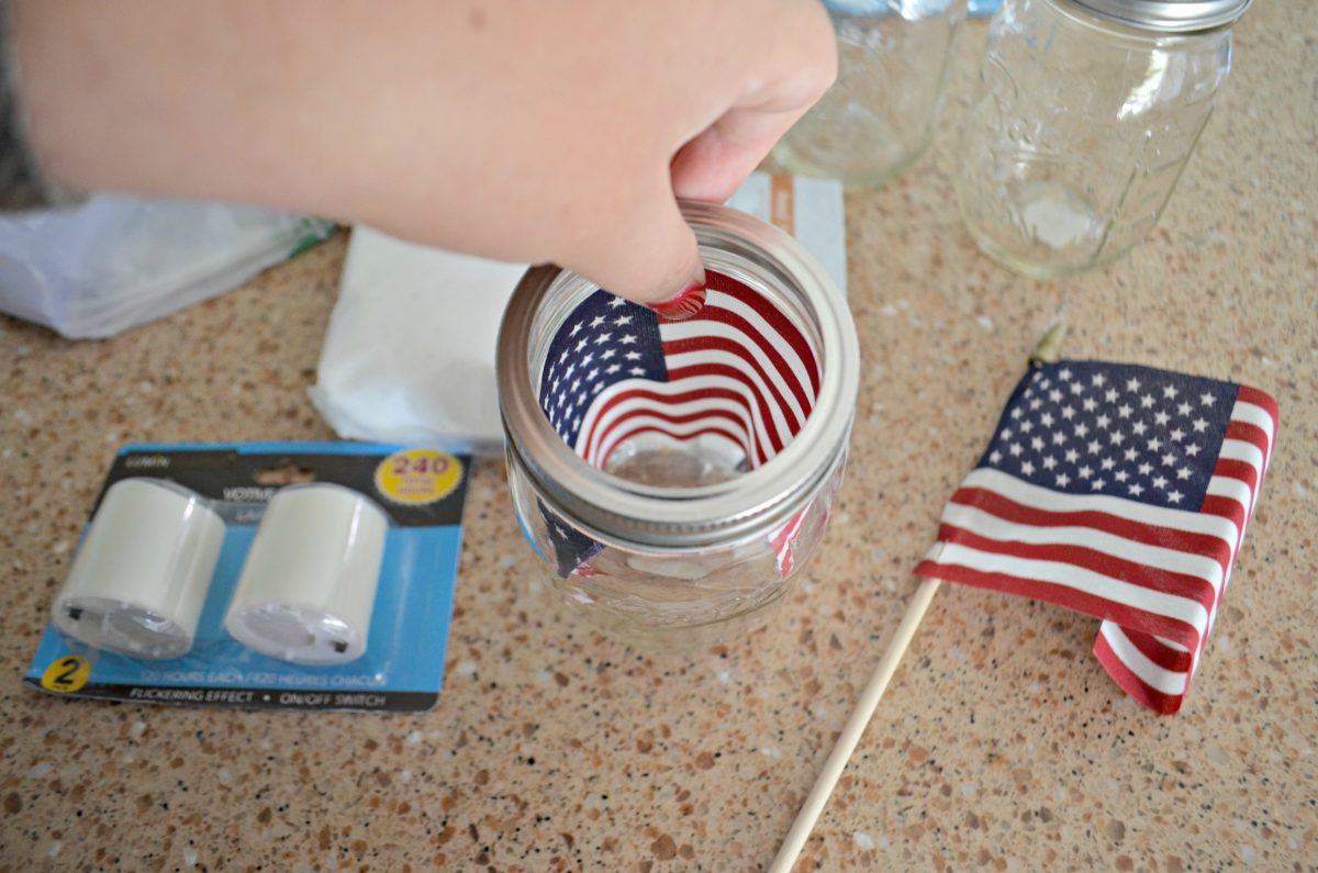 Dollar Tree 4th of July Craft Mason Jar Votives – using mini flags as a backdrop