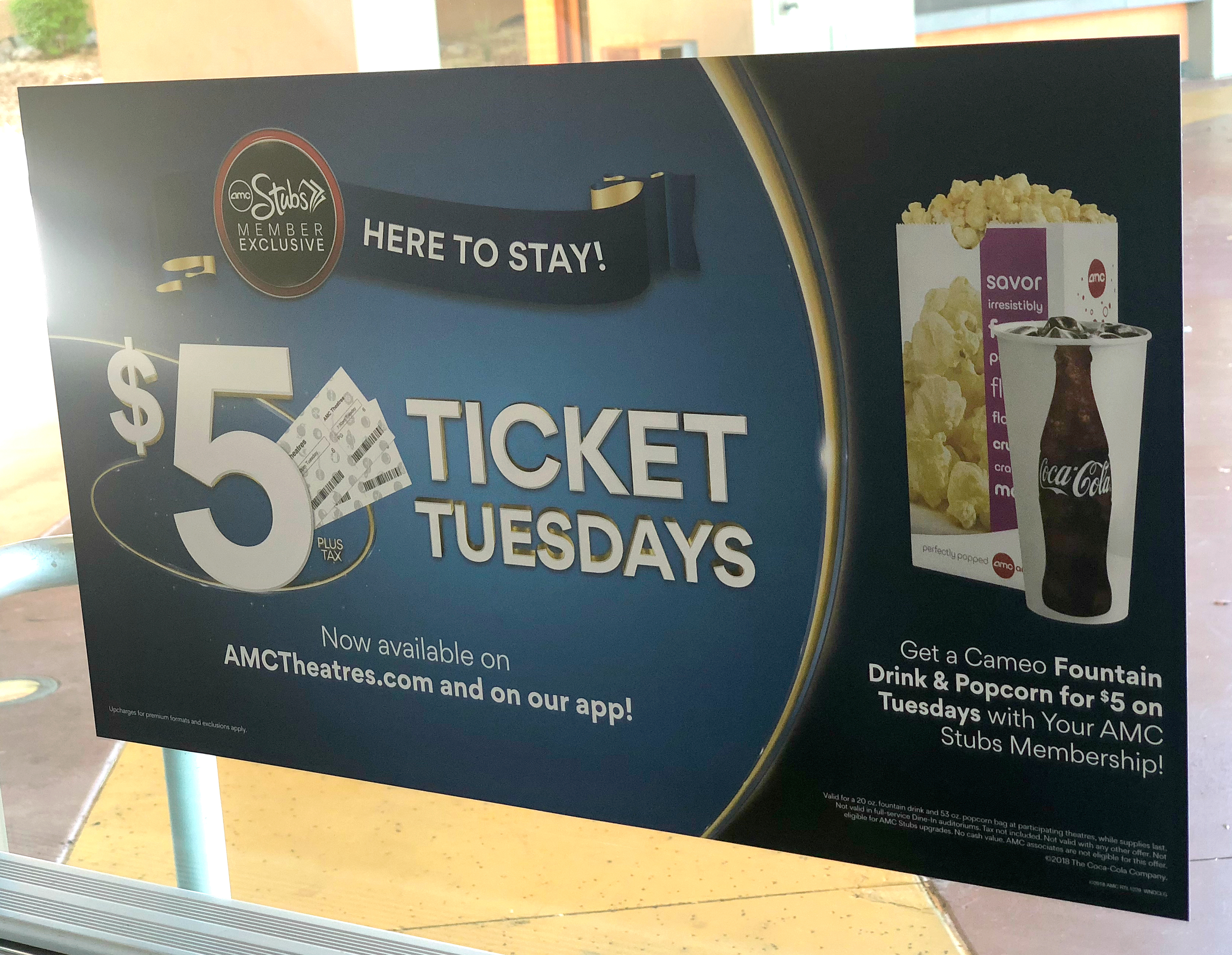 simple movie theater hacks that save money - AMC Ticket Tuesday sign