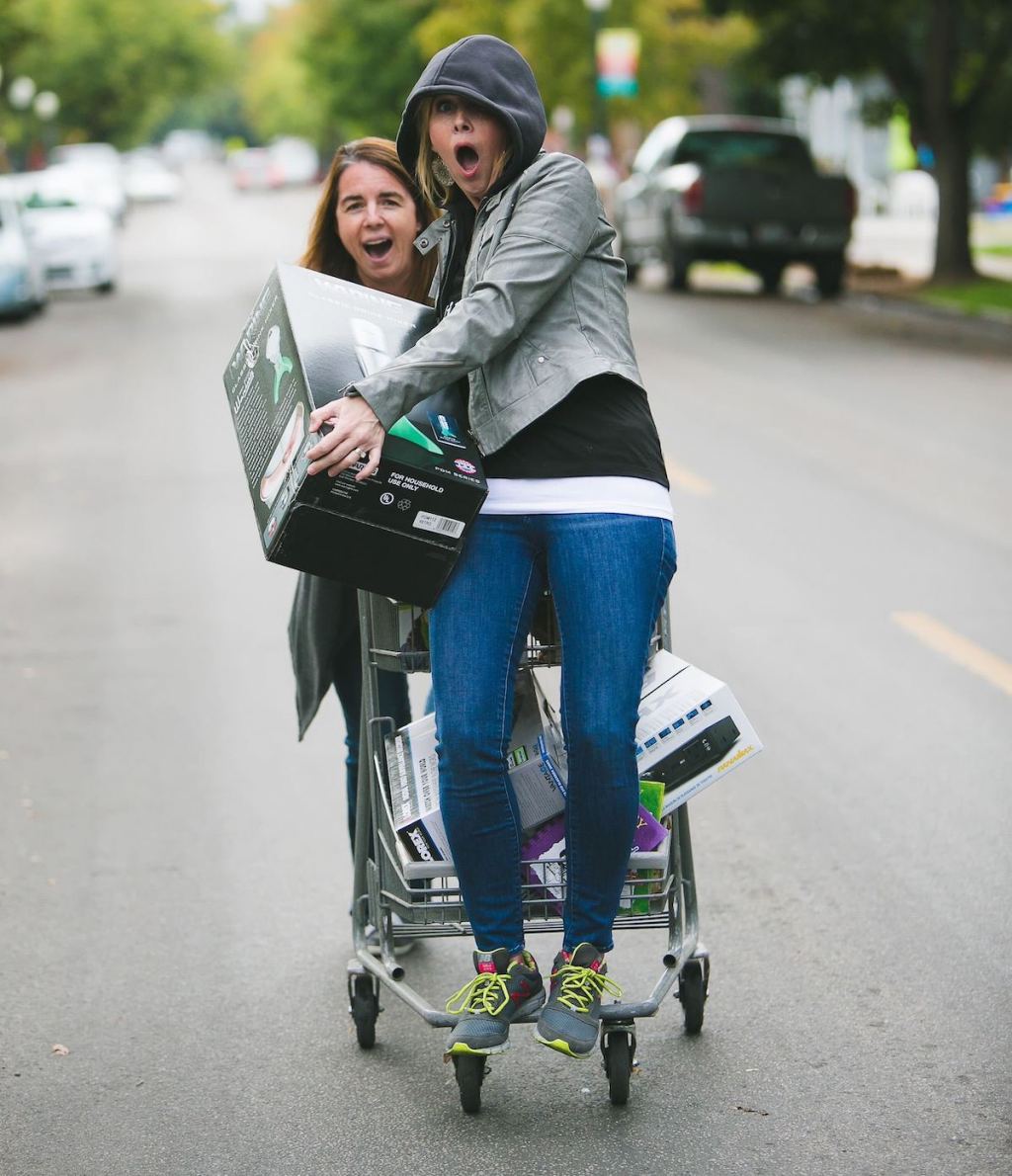 two women in street with cart and box