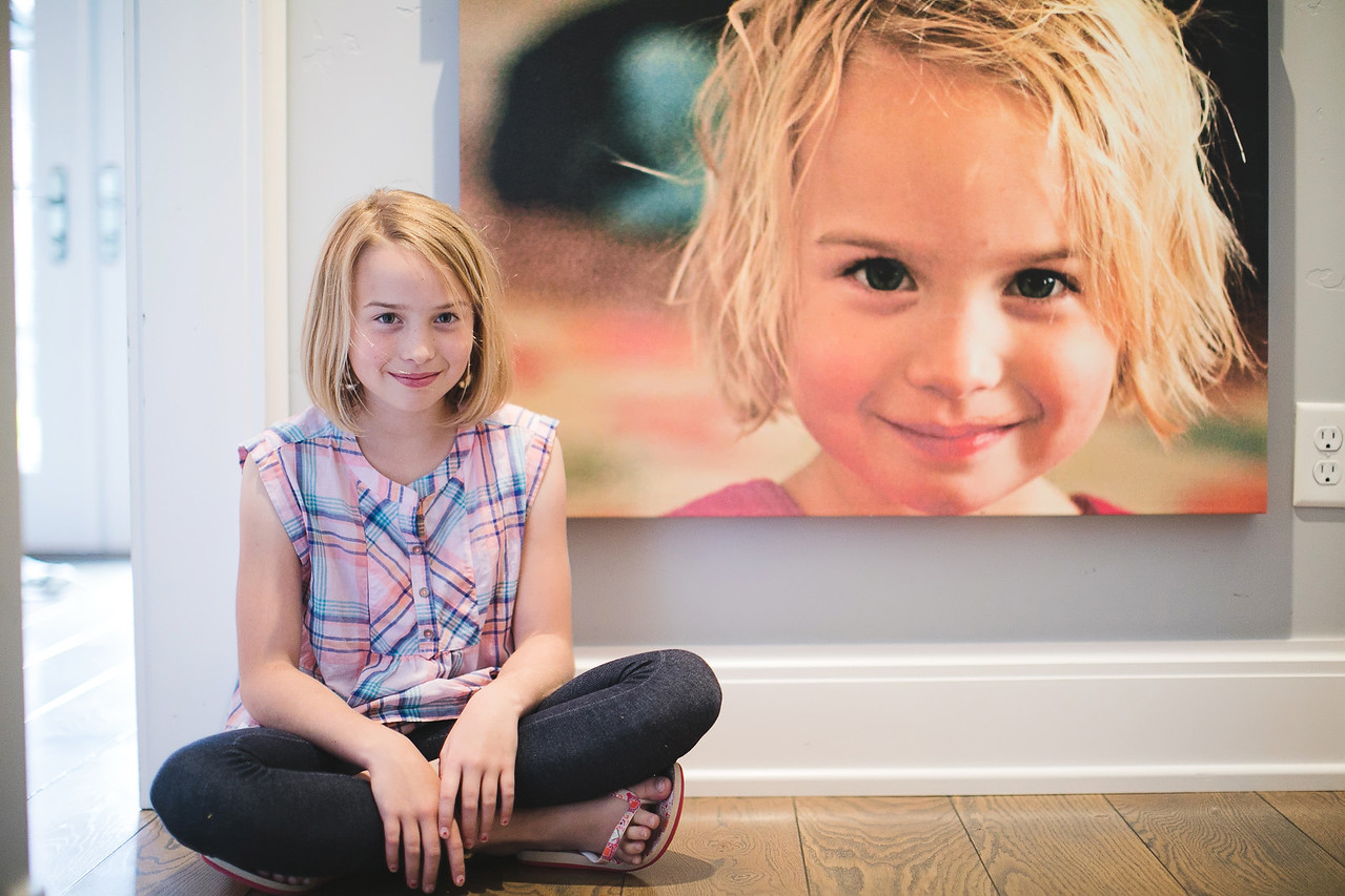 Cute girl sitting in front of custom canvas print