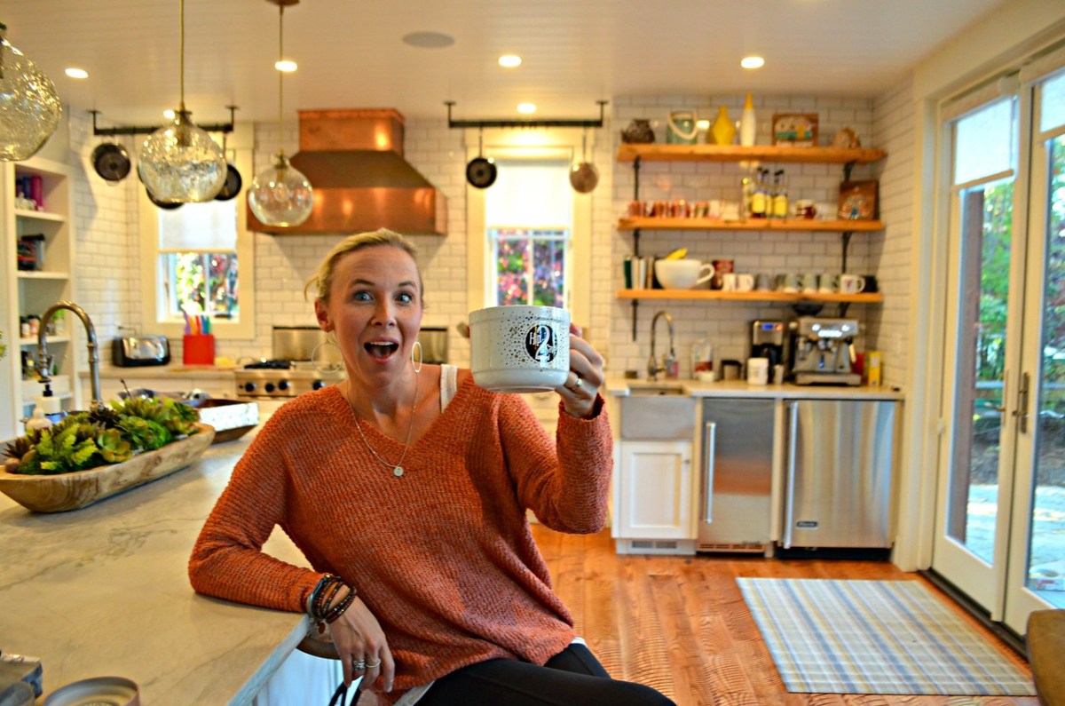 woman holding a large cup of coffee