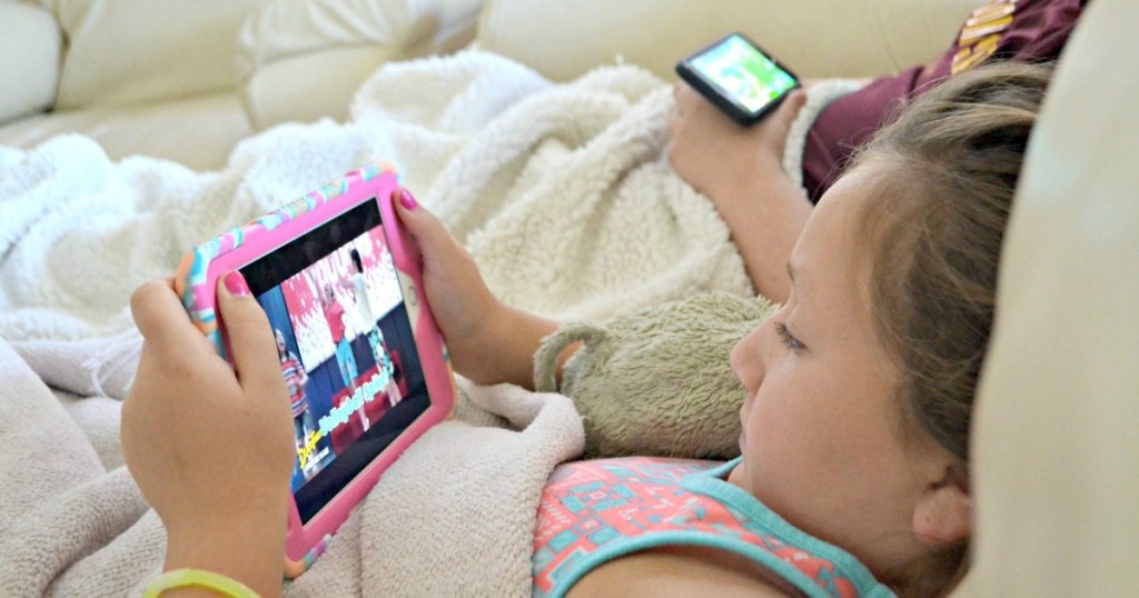 two kids looking at their iPads