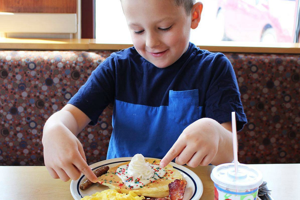 child eating pancakes