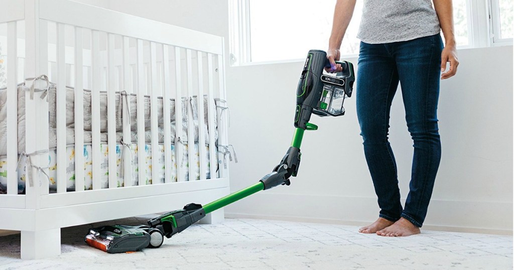 woman pushing a shark ionflex vacuum