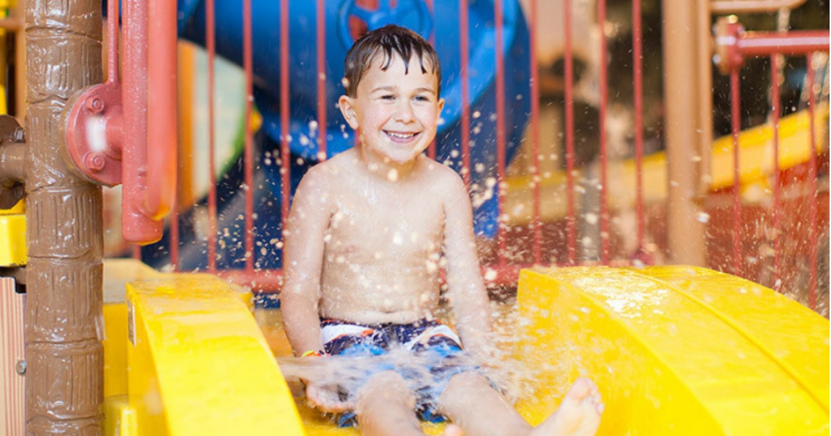 young boy sliding down water slide at Great Wolf Lodge
