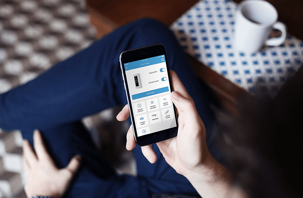 man holding cell phone with ring app opened