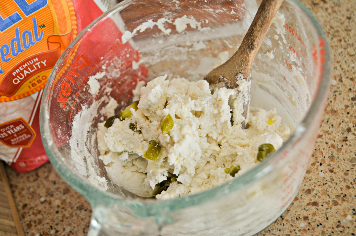 mixing dough with jalepenos in it