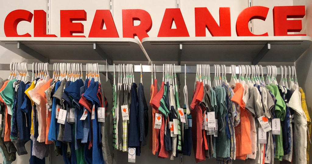 Wall of clothes with clearance signage at Carter's 