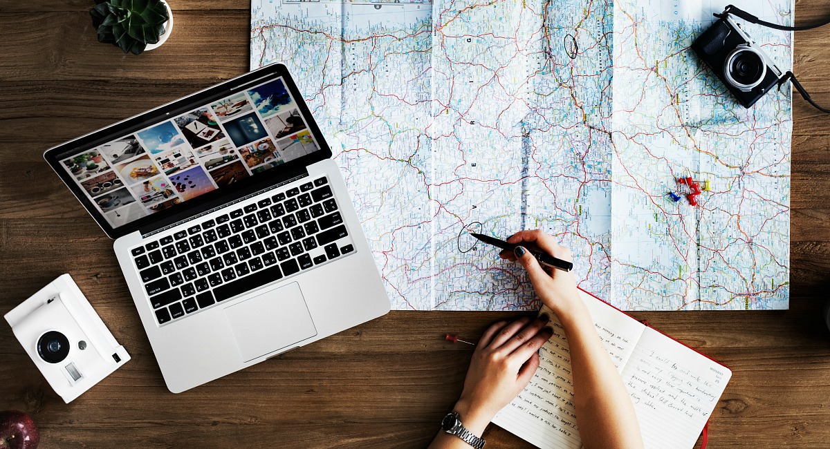 Money saving tips and hacks for airplane flights - planning out vacation with map and computer