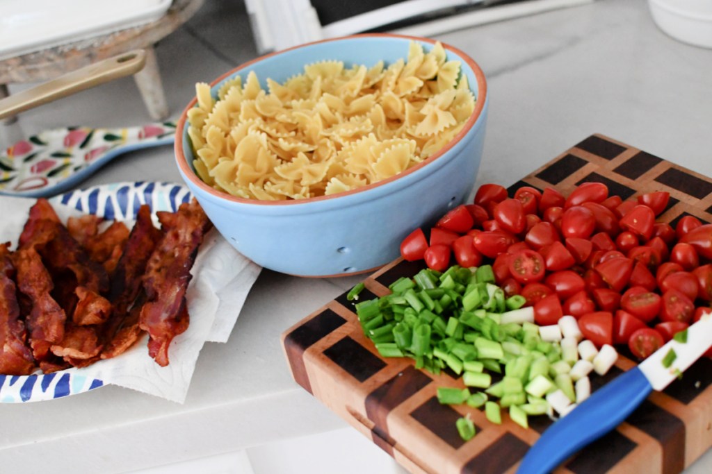 cooked pasta and cooked bacon with chopped veggies