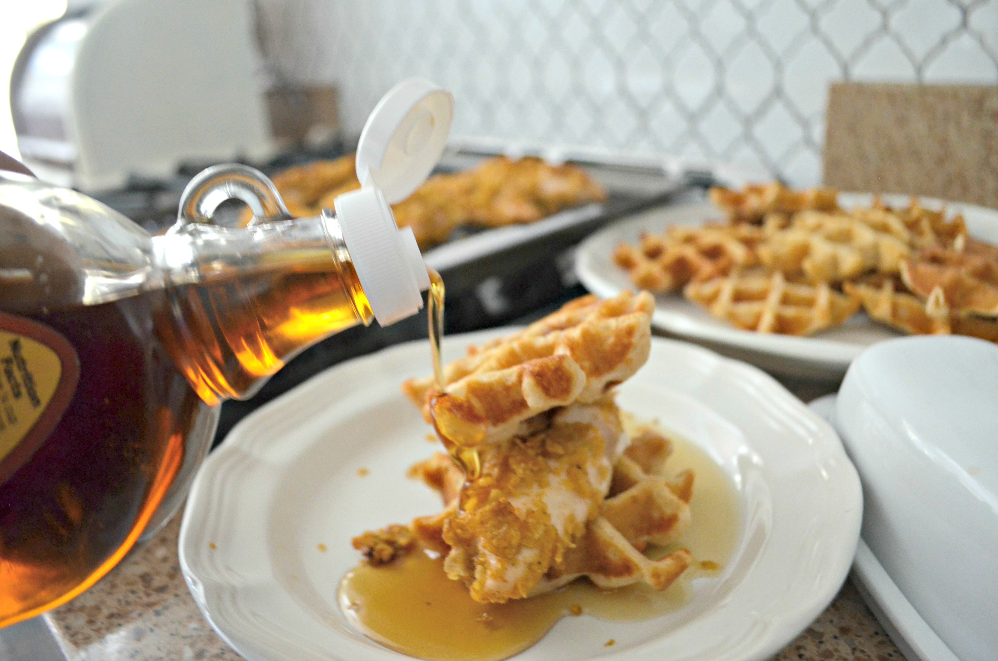 Easy Cornflake Chicken and Mini Waffles - pouring syrup over the waffles