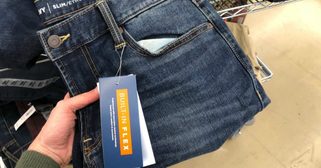 woman hand holding gap jeans in store