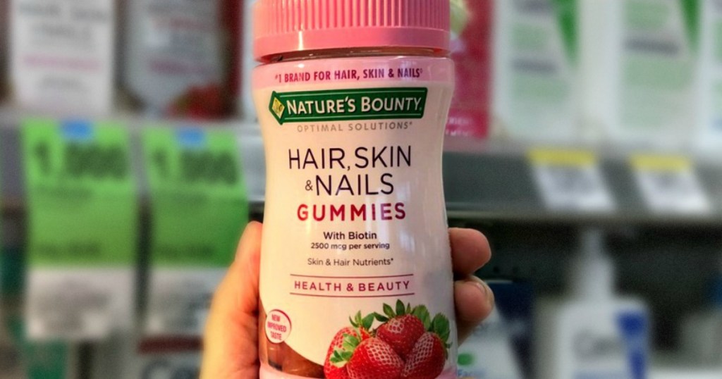 hand holding bottle of Nature's Bounty vitamins
