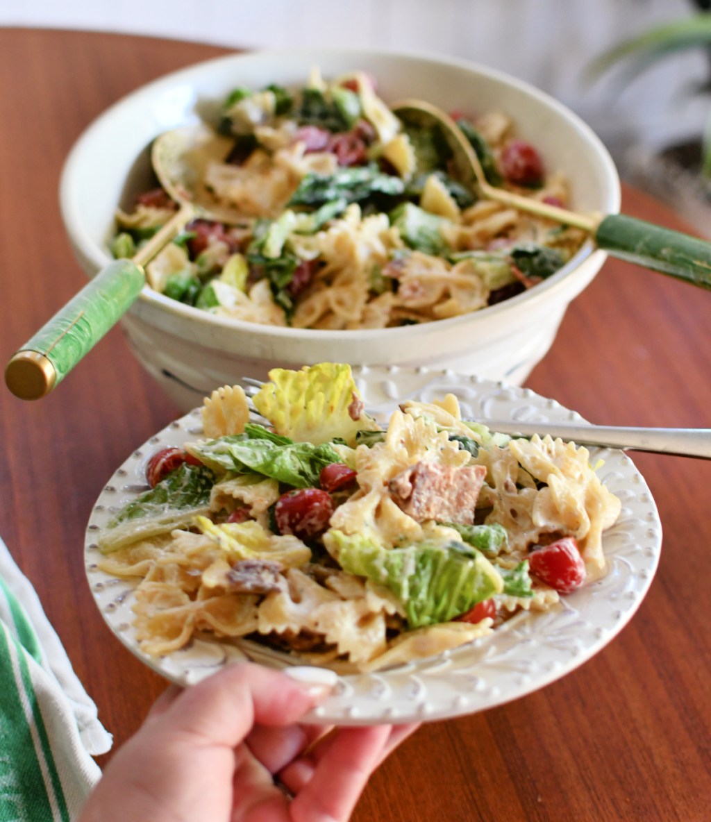 plate of salad next to the larger salad bowl