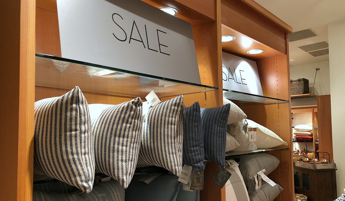 shop pottery barn with these money-saving tips – pottery barn wall of sale items with pillows on shelves
