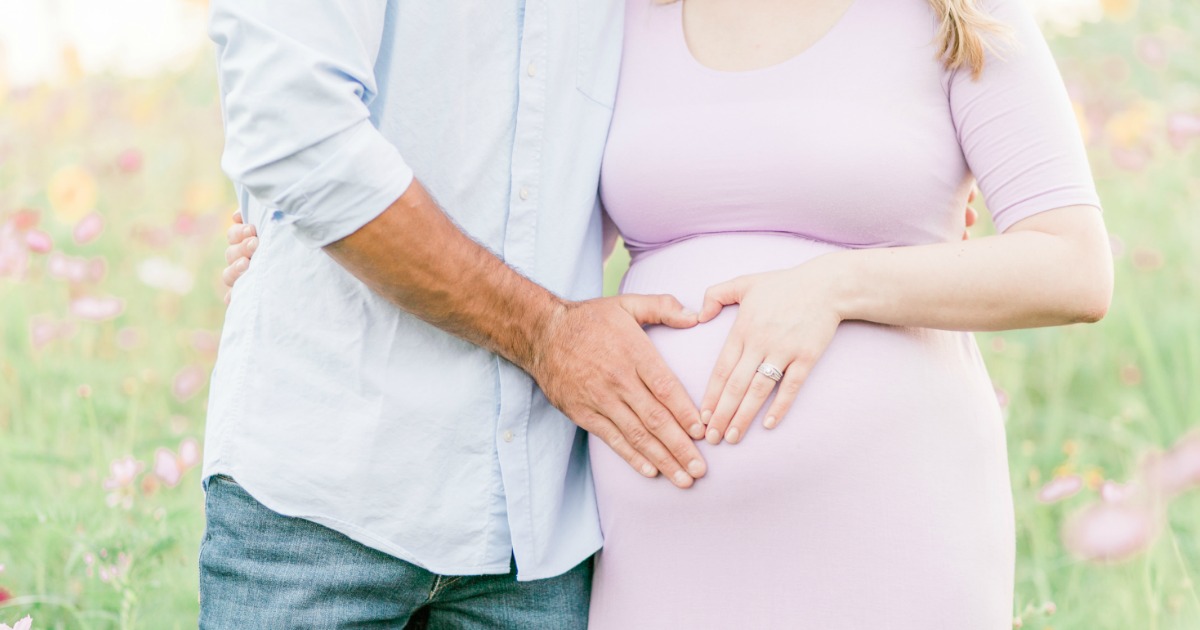 Get a free registry baby gift bag like for registering for your baby at Target! - mom and dad with their hands on mom's pregnant tummy