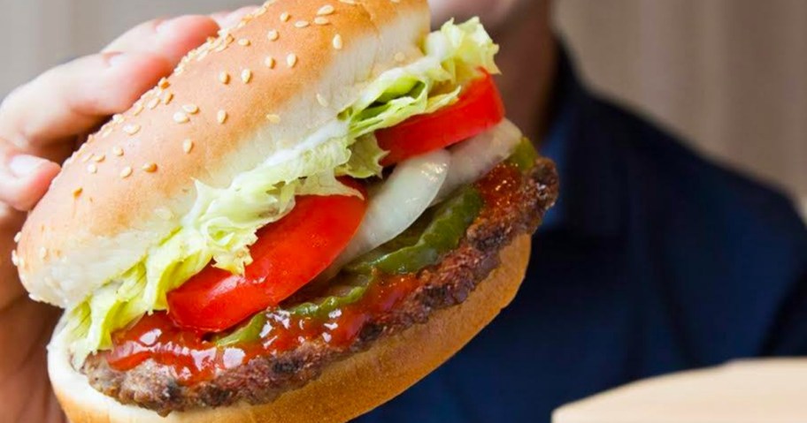 hand holding whopper sandwich