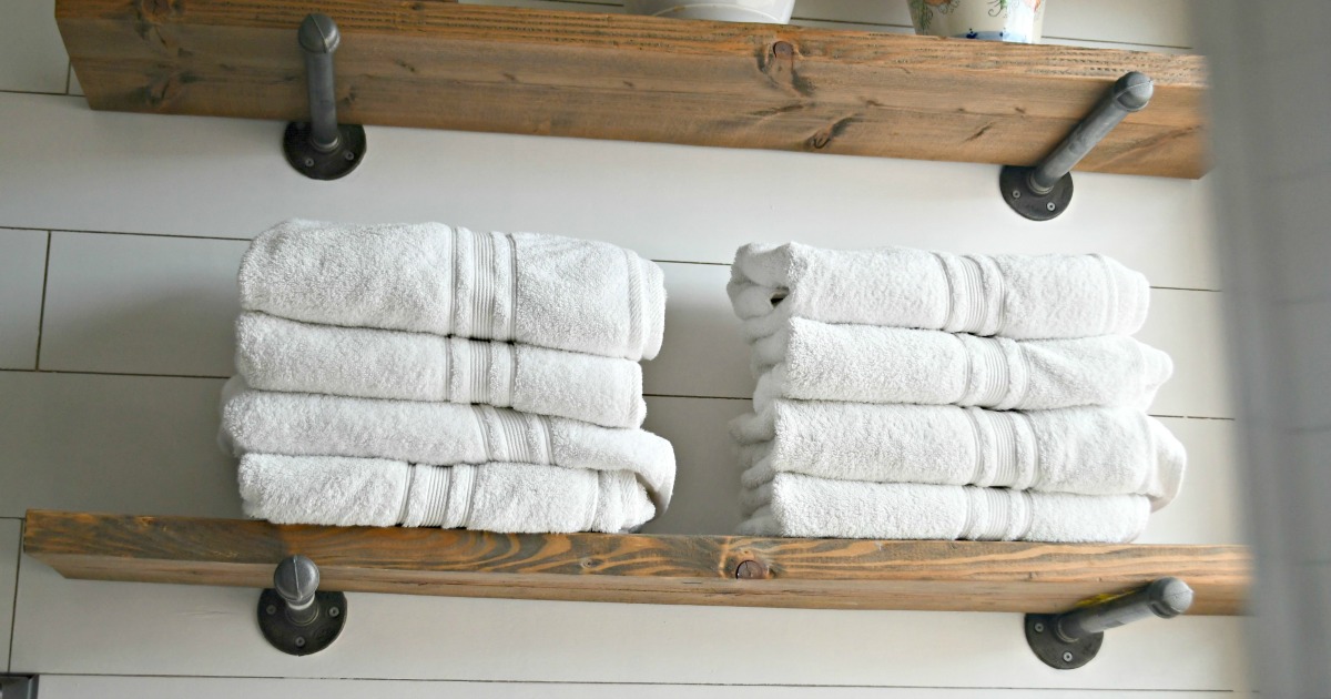 Costco Charisma Bath Towels Are Affordable & High-Quality – Stacked in a bathroom on shelves