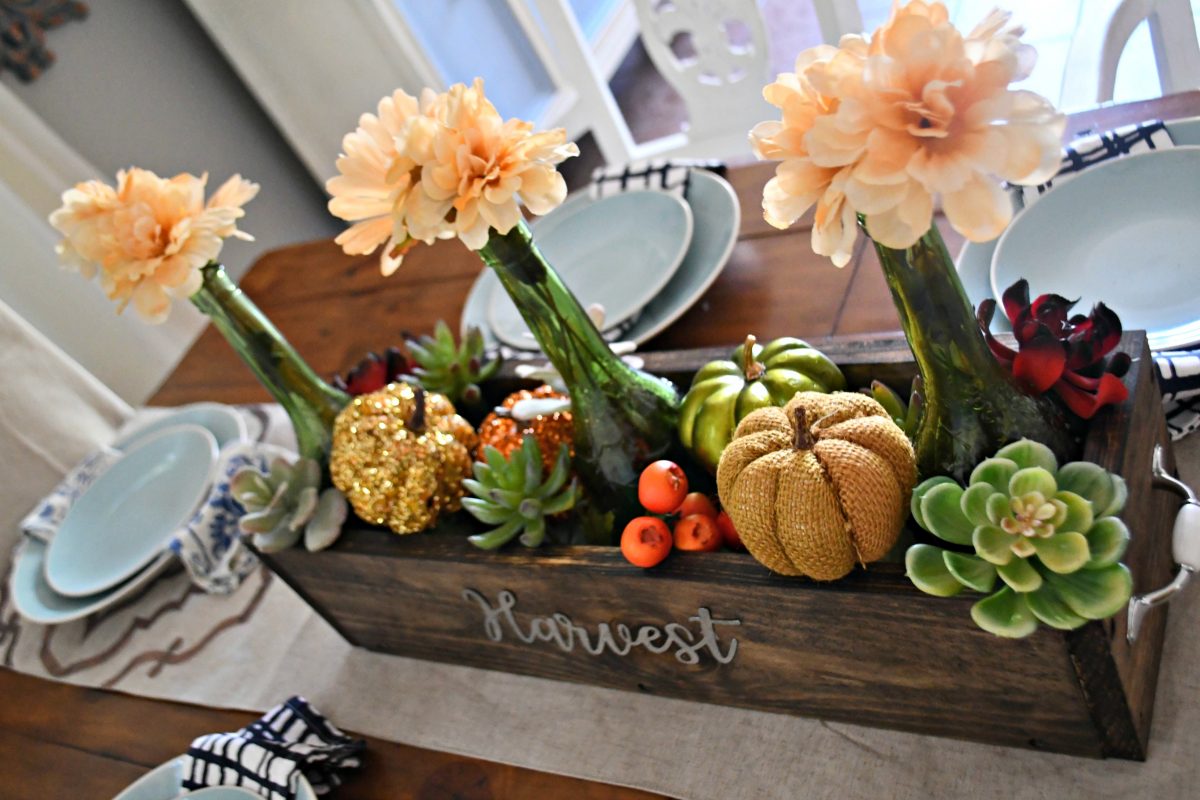 dollar tree fall centerpiece - one of my looks using bottles, succulents, and pumpkins