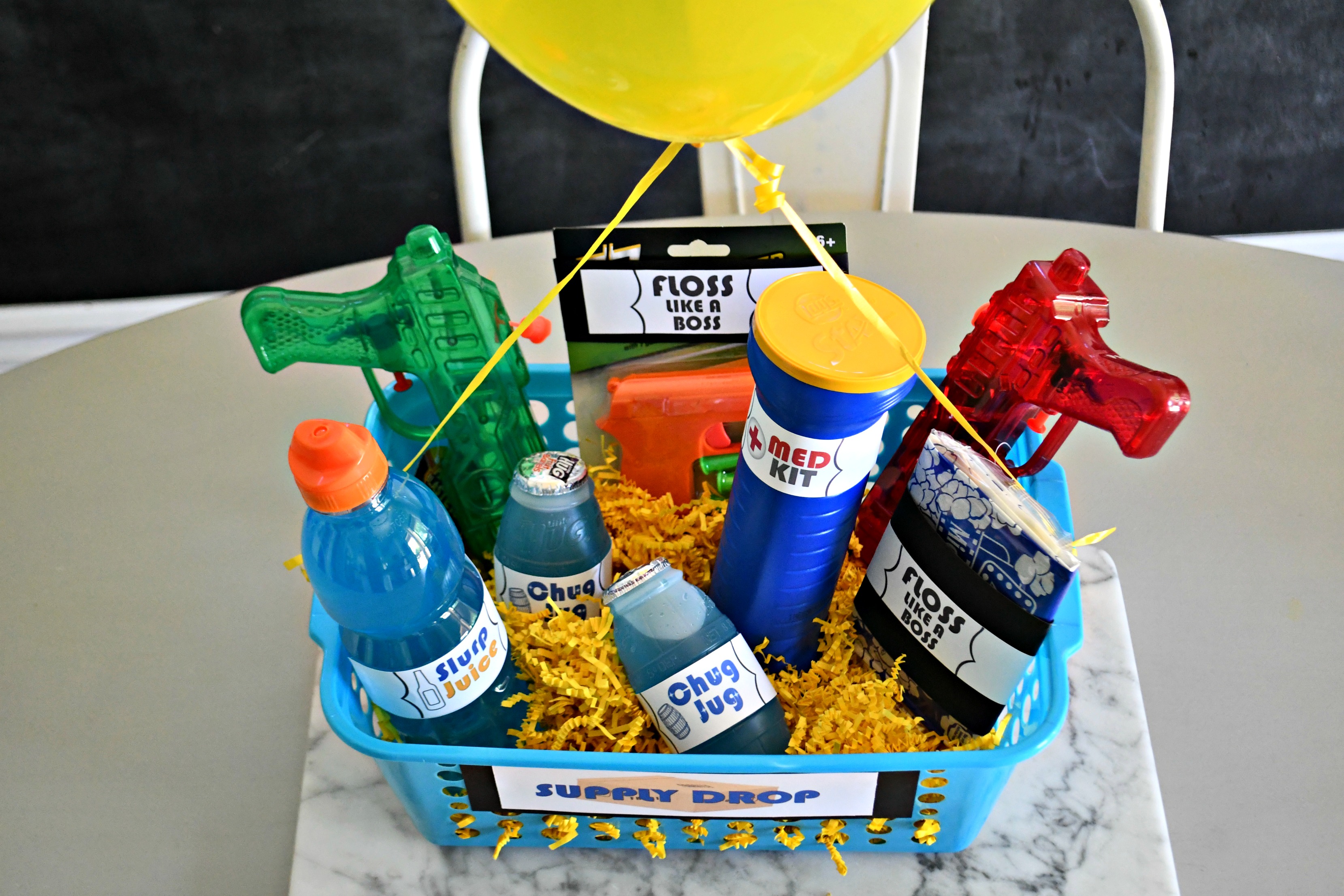 DIY Dollar Tree Fortnite Gift Basket in the supply drop basket with the balloon attached