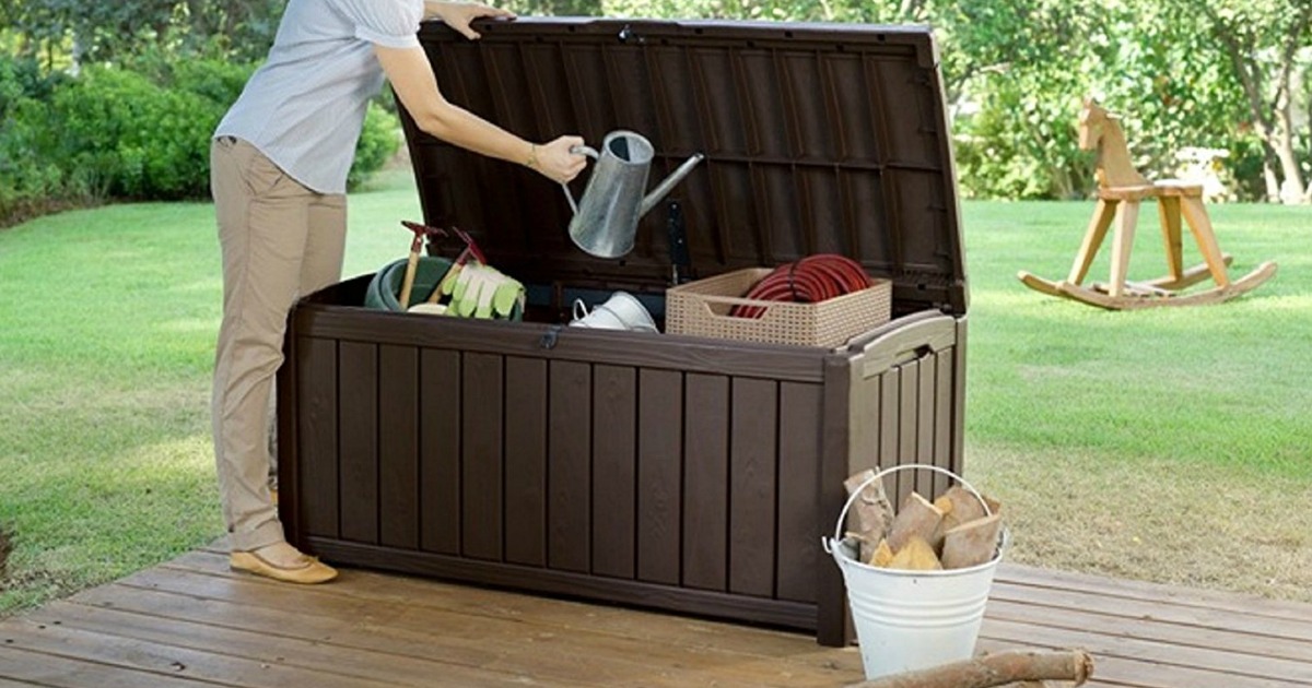 woman putting watering can in storage box