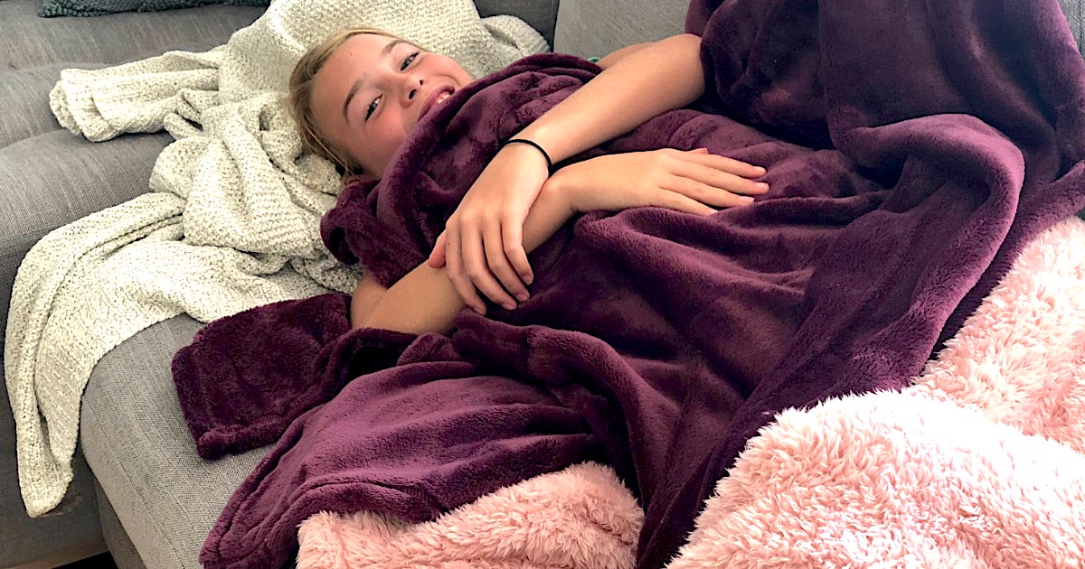 girl laying with blankets