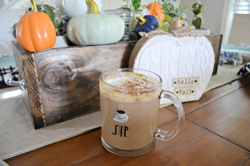 pumpkin spice latte on table with pumpkin centerpiece