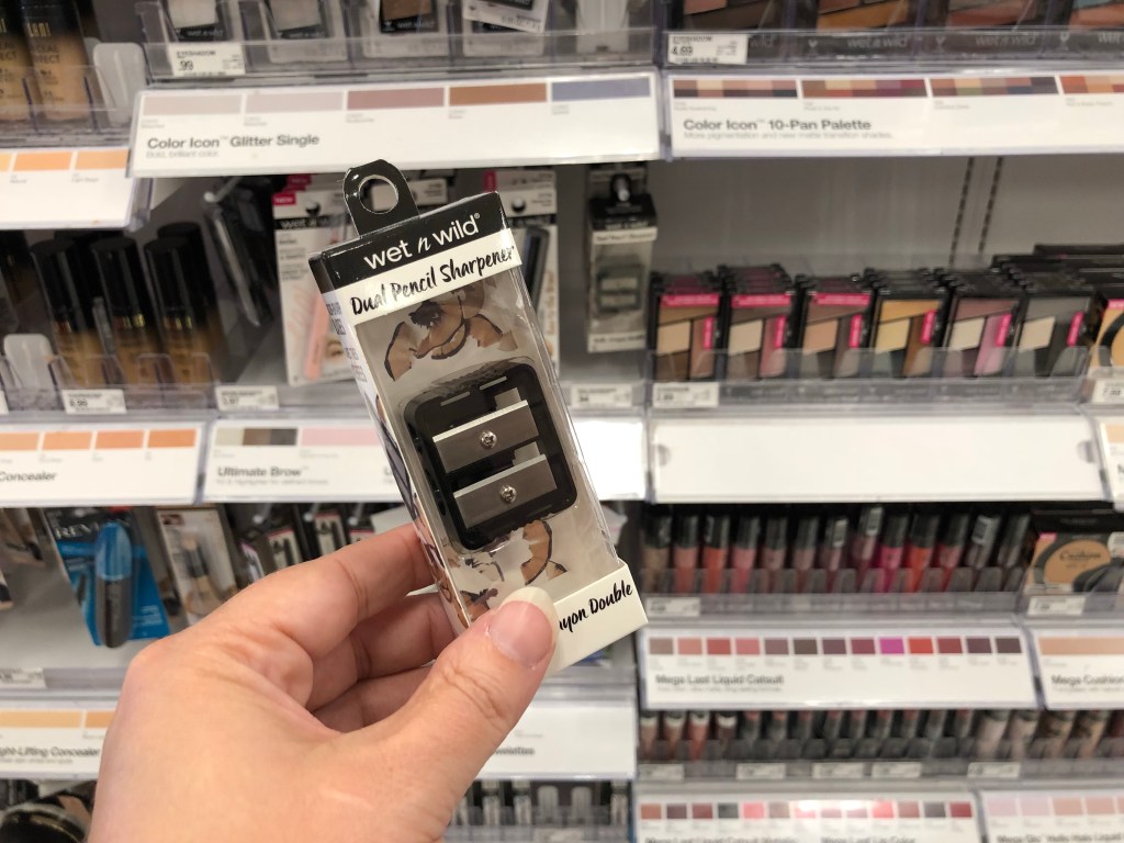 holding an eye makeup pencil sharpener