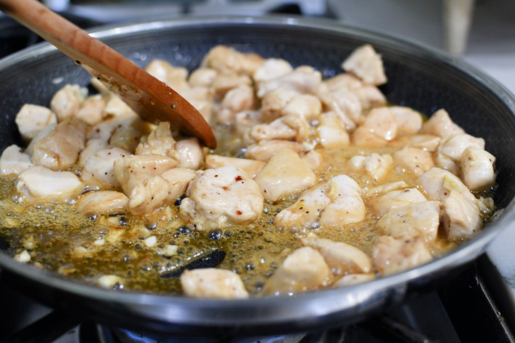 adding honey and ingredients to honey garlic chicken