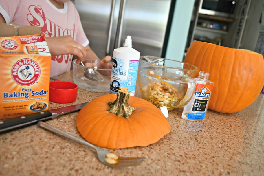 Girl making diy pumpkin slime for Halloween