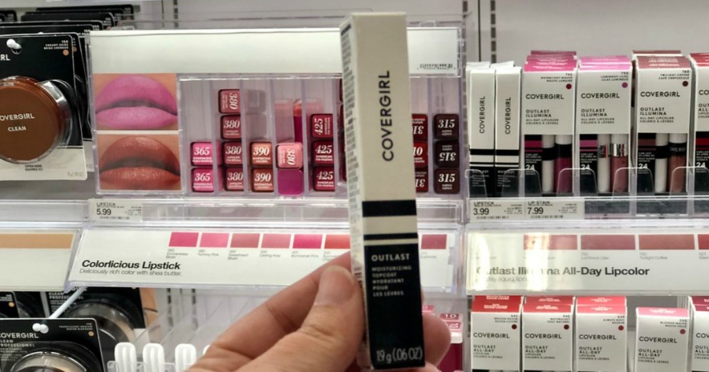 woman holding up covergirl lip stick at target