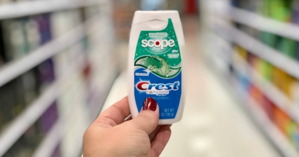 hand holding bottle of toothpaste 