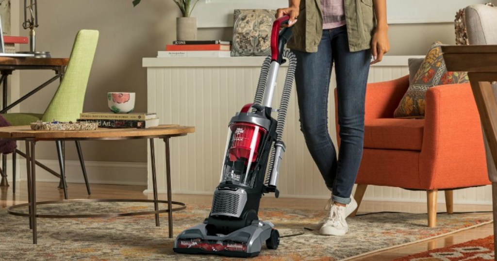 woman using red vacuum